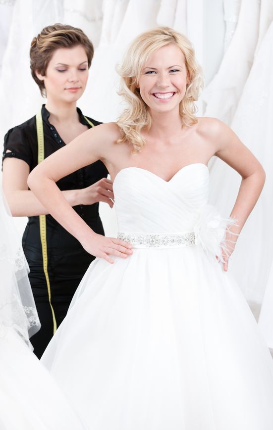 seamstress-adjusting-alterations-and-corset-on-bridal-gown